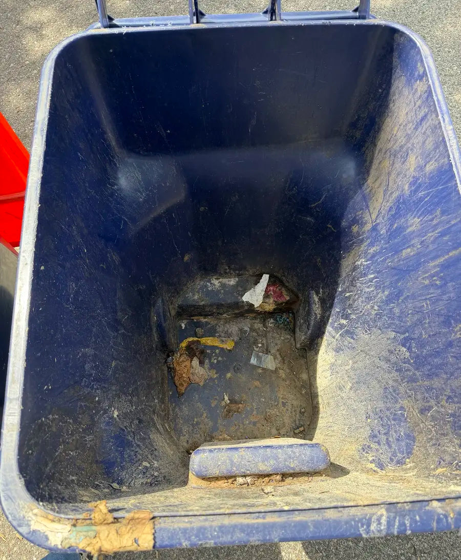 Dirty rollaway trash bin before BC Bin Clean service with grime and debris inside