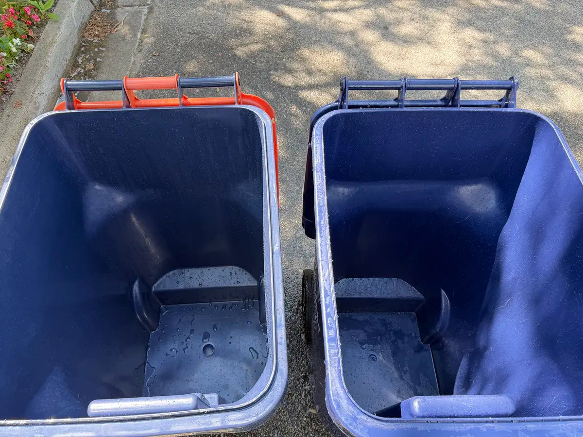 Second angle showing both freshly cleaned rollaway bins